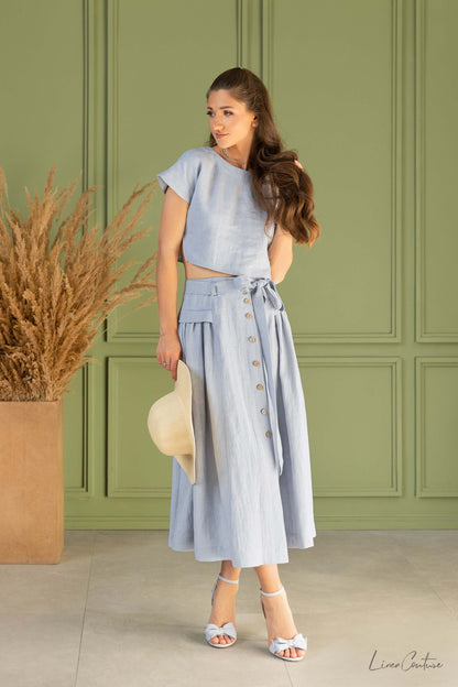 Taormina Set | Linen Crop Top and Flared Midi Skirt modeled in a natural setting with earthy tones and relaxed elegance.