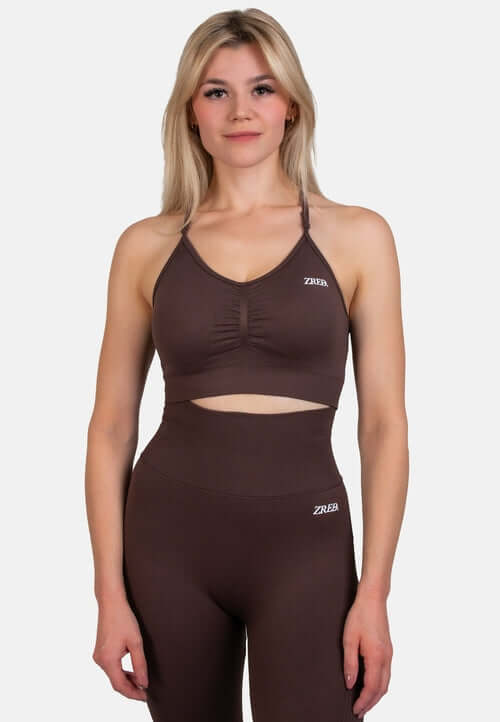 Model wearing the Shape Seamless Sports Bra in brown, paired with matching high-waisted leggings from ZRED.