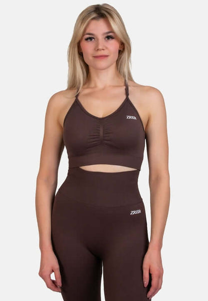 Model wearing the Shape Seamless Sports Bra in brown, paired with matching high-waisted leggings from ZRED.