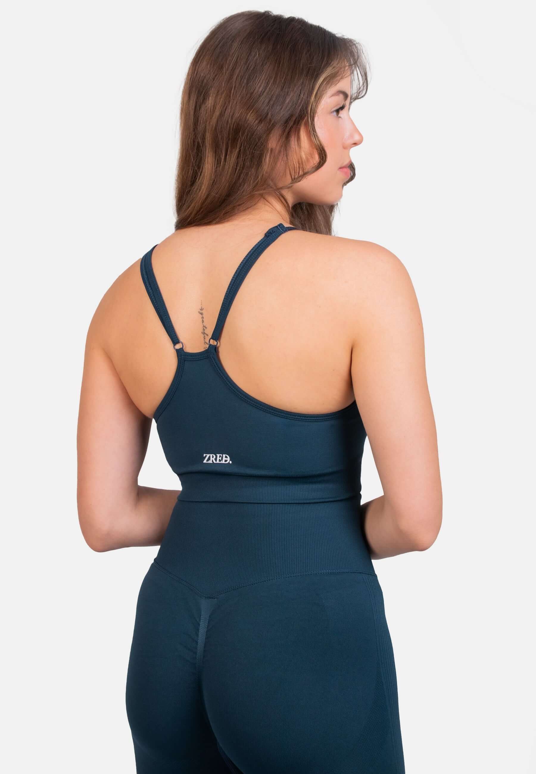 Shape Seamless Sports Bra in navy color, featuring adjustable straps and removable pads, shown from the back.